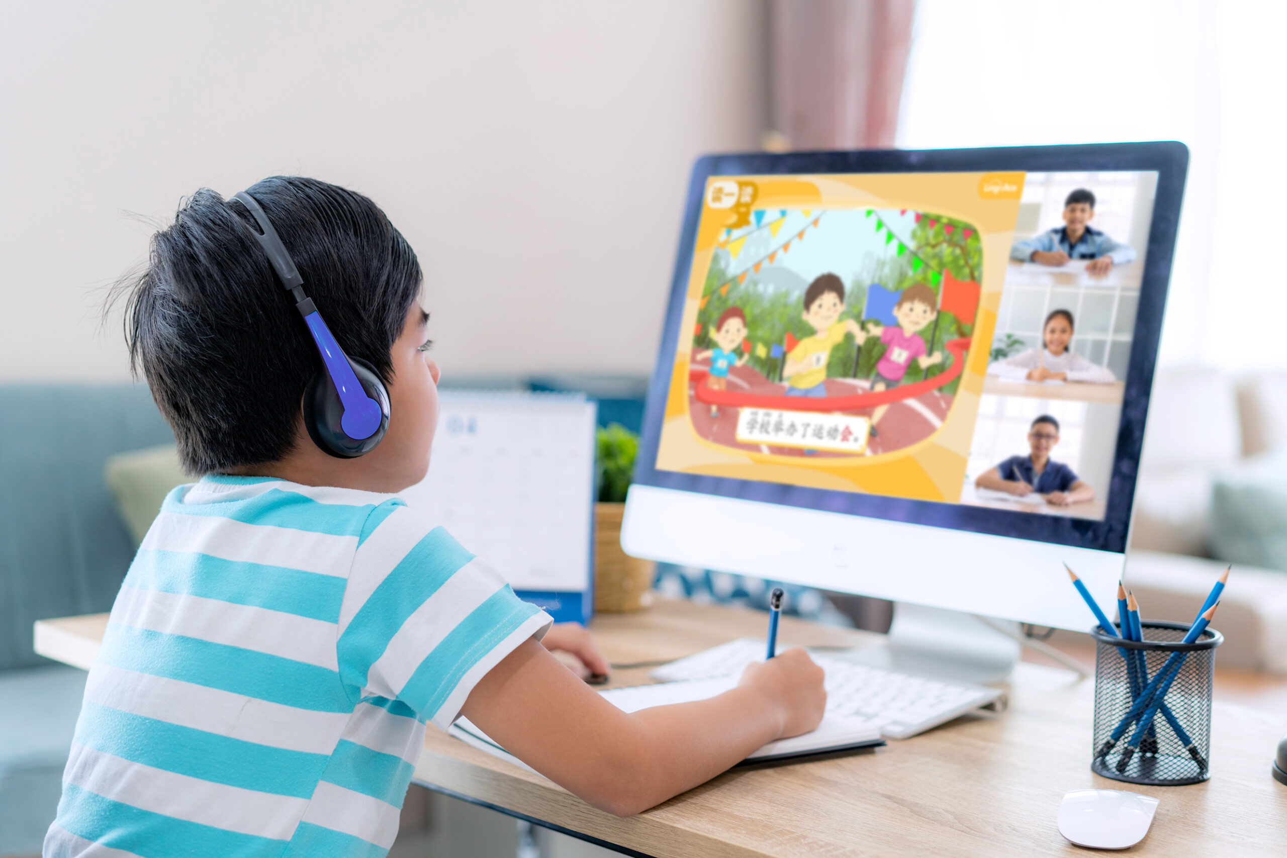 A boy concentrates on his 1-to-4 online Chinese class