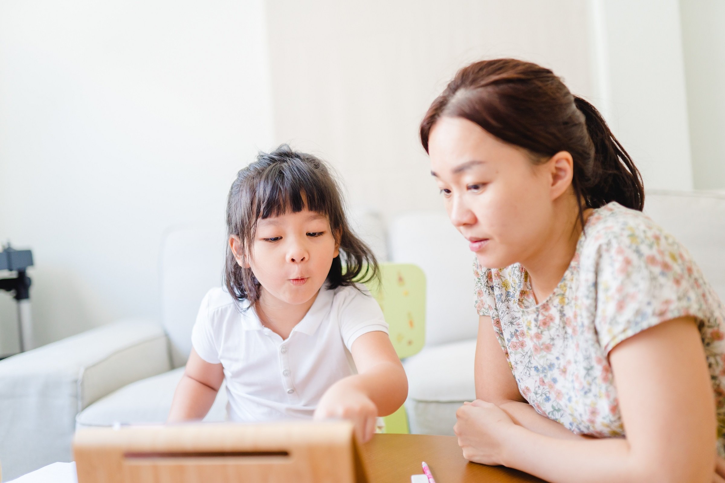 Covid-19 Coronavirus and Online learning from home, Home school kid.Little asian girl study with online learning class with mother work from home with tablet.Stay home,New normal, Social distancing