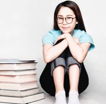 Beautiful asian female students during the exam Stay home and stressful and lazy reading books