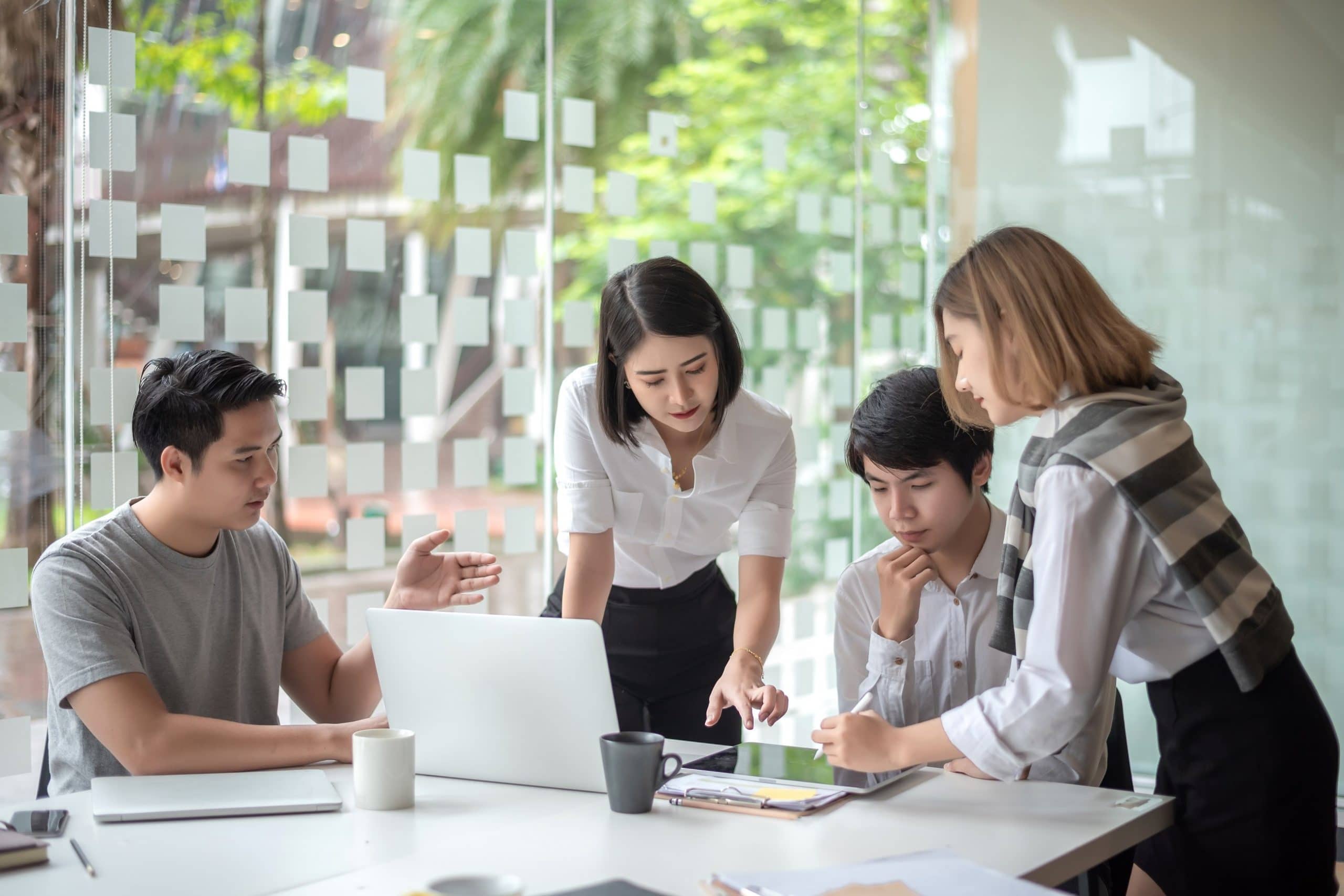 Group of young business people brainstorming at a meeting starting a new business